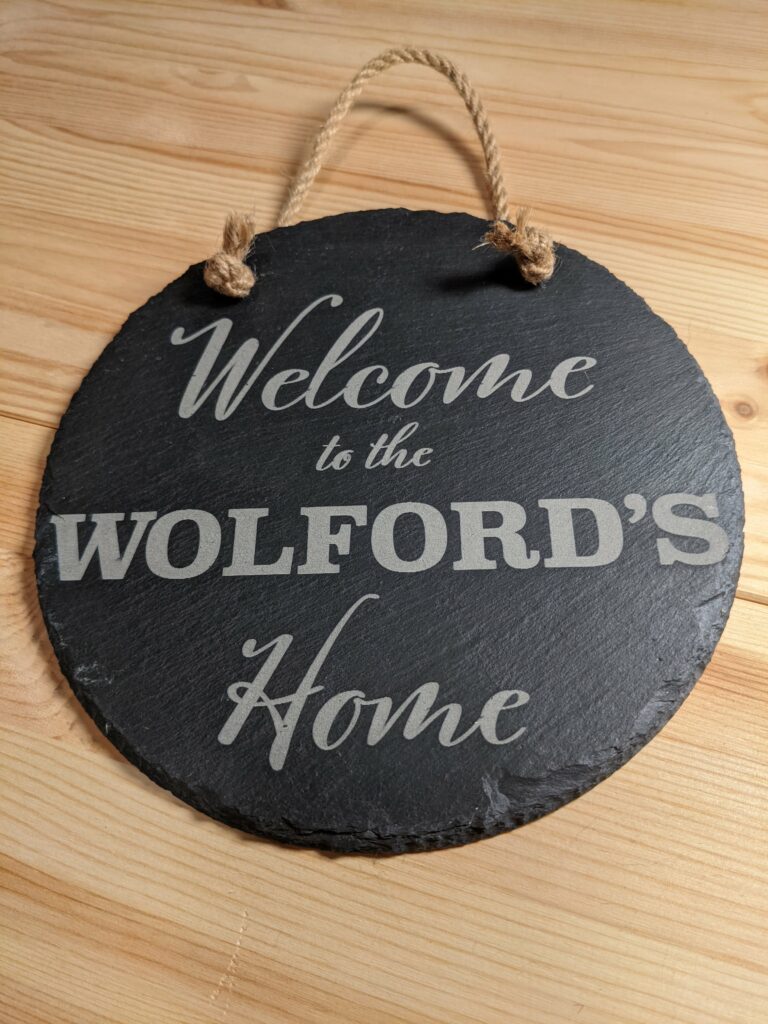 Slate sign shown with the words "Welcome to the Wolford's Home" on it