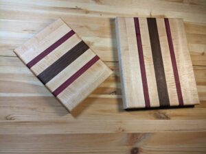 Maple cutting board with walnut and purple heart stripes with matching cheese board